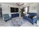 Cozy living room showcasing a loveseat, accent chair, and a stylish blue console at 817 Blue Heron Blvd, Ruskin, FL 33570