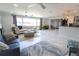 Spacious living room featuring modern decor, ceiling fans, and white marble floors with beautiful rugs at 817 Blue Heron Blvd, Ruskin, FL 33570
