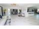 Bright open-concept living room featuring stylish decor, marble floors, and seamless flow to the dining area at 817 Blue Heron Blvd, Ruskin, FL 33570