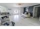 Bright living room with white marble floors and neutral decor is designed for modern comfort and style at 817 Blue Heron Blvd, Ruskin, FL 33570