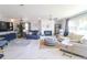 Bright living room with a fireplace, lots of seating, and white marble floors at 817 Blue Heron Blvd, Ruskin, FL 33570