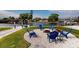 Inviting outdoor space with blue chairs around a fire pit, perfect for enjoying waterfront views and outdoor gatherings at 817 Blue Heron Blvd, Ruskin, FL 33570