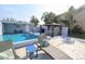 Relaxing outdoor pool area with a gazebo featuring an outdoor dining set, along with comfortable lounge seating at 817 Blue Heron Blvd, Ruskin, FL 33570