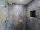 Elegant shower with dark stone-look tile, a niche, and brass fixtures at 817 Blue Heron Blvd, Ruskin, FL 33570