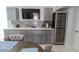 A wet bar with grey cabinets, stylish backsplash, and a wine fridge at 817 Blue Heron Blvd, Ruskin, FL 33570