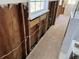 A bathroom undergoing renovations with exposed framing and a partially tiled floor leading to a shower at 9015 Bay Ne St, St Petersburg, FL 33702