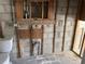 A bathroom under construction with exposed concrete block walls and newly installed plumbing fixtures at 9015 Bay Ne St, St Petersburg, FL 33702