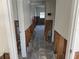 A hallway undergoing renovations with exposed framing and unfinished walls leading to other areas of the house at 9015 Bay Ne St, St Petersburg, FL 33702