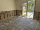 Renovation-ready room with exposed block walls and a sliding glass door leading to the backyard at 9015 Bay Ne St, St Petersburg, FL 33702
