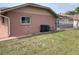 Backyard view featuring a well maintained lawn and a screened-in patio at 3604 Bula Ln, North Port, FL 34287