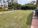 Spacious backyard with green lawn and mature trees provides plenty of room at 3604 Bula Ln, North Port, FL 34287