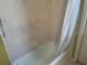 Bathroom features a standard bathtub with shower and tiled walls at 3604 Bula Ln, North Port, FL 34287