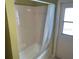 Bathroom features a standard bathtub with shower and tiled walls at 3604 Bula Ln, North Port, FL 34287