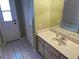 Bathroom with tile floors, door to outside, and standard sink vanity at 3604 Bula Ln, North Port, FL 34287