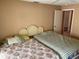 Comfortable bedroom with two beds, ceiling fan, neutral walls, and a doorway at 3604 Bula Ln, North Port, FL 34287