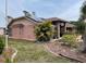 Side yard view showing the home's architectural style, landscaping, and solar panels at 3604 Bula Ln, North Port, FL 34287