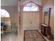 Inviting foyer with tile flooring, large arched window, and elegant decor at 3604 Bula Ln, North Port, FL 34287