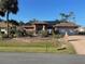 Inviting single-story home with solar panels, long drive, mature plants and a decorative front yard at 3604 Bula Ln, North Port, FL 34287