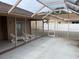 Spacious screened patio with lounge chairs and privacy screen at 3604 Bula Ln, North Port, FL 34287