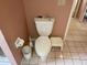 A standard toilet with a white tank and bowl, complemented by a matching step stool at 3604 Bula Ln, North Port, FL 34287