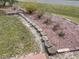 Landscaped yard features plants and brick borders; yard could use some TLC at 3604 Bula Ln, North Port, FL 34287