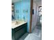 Bright bathroom with a shower/tub combo, blue walls, and tile flooring at 1612 Pocatello St, Sarasota, FL 34231