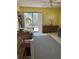 Comfortable bedroom with a large window offering plenty of natural light, complemented by a dresser and desk at 1612 Pocatello St, Sarasota, FL 34231