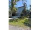 Two-story blue home with lush landscaping and a long driveway leading up to the entrance at 1612 Pocatello St, Sarasota, FL 34231