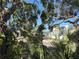 Water view from property showing houses in background with mature landscaping and trees in the foreground at 1612 Pocatello St, Sarasota, FL 34231