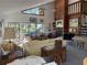 Spacious living room with large windows, fireplace, piano, and vaulted ceilings at 1612 Pocatello St, Sarasota, FL 34231