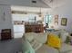 Bright and airy living room with a cozy sofa, seamlessly flowing into a kitchen with an island bar and dining area at 1612 Pocatello St, Sarasota, FL 34231