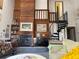 Cozy living room featuring a fireplace, piano, spiral staircase, and wood-paneled wall at 1612 Pocatello St, Sarasota, FL 34231