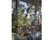 Screened porch with lush landscaping and a view of the street and surrounding trees at 1612 Pocatello St, Sarasota, FL 34231