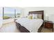 Comfortable bedroom featuring bed with pillows and a scenic water view from a large window at 6365 Bahia Del Mar Blvd # 210, St Petersburg, FL 33715