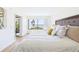Inviting bedroom featuring comfortable bed and water views from large window at 6365 Bahia Del Mar Blvd # 210, St Petersburg, FL 33715