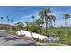 Community entrance sign, lush landscaping, and palm trees lining the street create a welcoming atmosphere at 6365 Bahia Del Mar Blvd # 210, St Petersburg, FL 33715