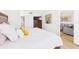 Serene main bedroom with a comfortable bed, dresser, and a view into the living room at 6365 Bahia Del Mar Blvd # 210, St Petersburg, FL 33715