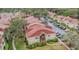 Aerial view of community with red roofs and extensive parking at 9481 Highland Oak Dr # 715, Tampa, FL 33647