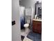 Bathroom featuring a granite countertop, dark wood cabinets and a toilet at 9481 Highland Oak Dr # 715, Tampa, FL 33647