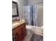 Functional bathroom featuring vanity with stone countertops, mirror, and shower-tub combination at 9481 Highland Oak Dr # 715, Tampa, FL 33647