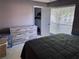 Bedroom with a wooden dresser, closet and windows with horizontal blinds at 9481 Highland Oak Dr # 715, Tampa, FL 33647