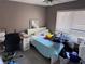 Bedroom with a desk, chair, queen size bed and blinds on the window at 9481 Highland Oak Dr # 715, Tampa, FL 33647