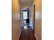 Hallway with hardwood floors, doors, and view of bedroom at 9481 Highland Oak Dr # 715, Tampa, FL 33647