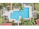 Aerial view of a community pool with lounge chairs and lush landscaping at 9481 Highland Oak Dr # 715, Tampa, FL 33647