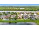 Aerial view of homes along a lake, showcasing swimming pools and well-manicured lawns at 18441 New London Ave, Land O Lakes, FL 34638