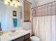Bathroom featuring vanity with a solid surface countertop, mirror, and shower with curtain at 18441 New London Ave, Land O Lakes, FL 34638