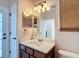 Bathroom features vanity with a solid surface countertop, mirror, and private toilet room at 18441 New London Ave, Land O Lakes, FL 34638