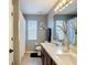 Bathroom with double sinks, quartz countertops, a neutral color scheme, and plenty of natural light from the window at 18441 New London Ave, Land O Lakes, FL 34638