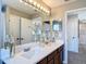 Modern bathroom features a double sink vanity, a large mirror, and stylish decor, creating a luxurious feel at 18441 New London Ave, Land O Lakes, FL 34638