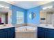 Bright bathroom featuring dual sinks and large soaking tub at 18441 New London Ave, Land O Lakes, FL 34638